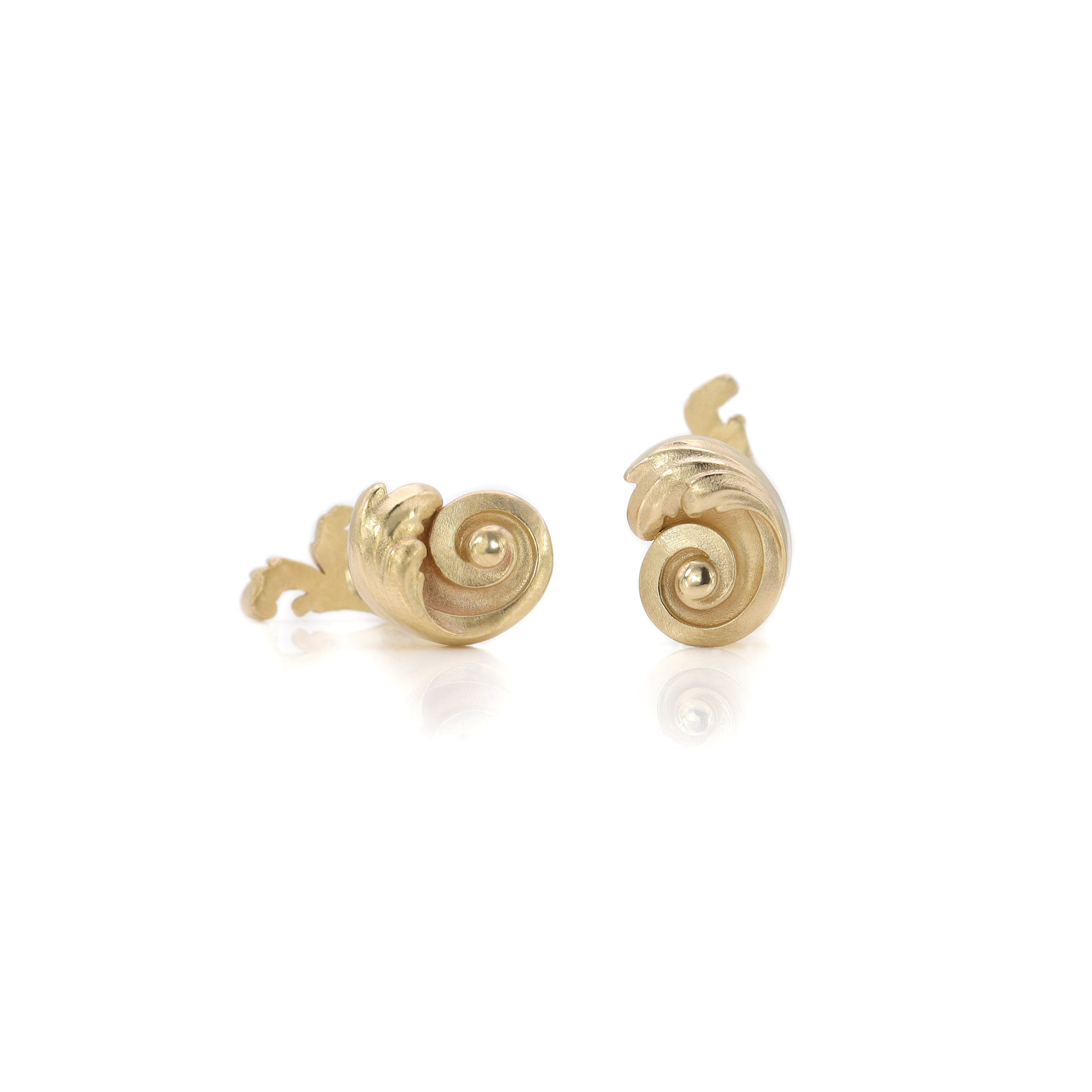 Pair of gold Acanthus leaf cufflinks  on a white background