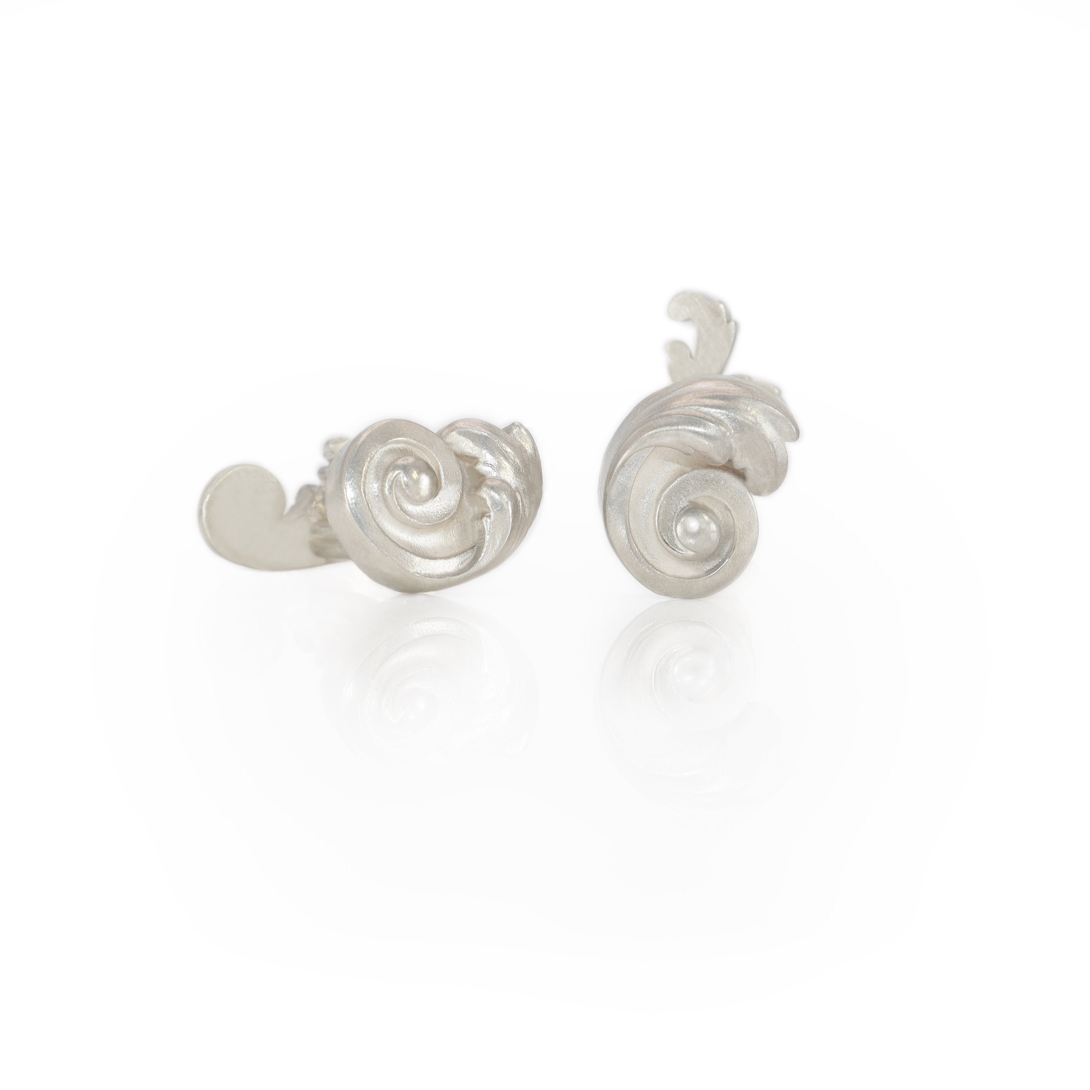 Pair of silver Acanthus leaf cufflinks on a white background